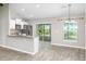Modern kitchen with stainless steel appliances, white cabinetry, and bar seating at 30 Olive Cir, Ocala, FL 34472