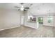 Open-concept living space with modern floors and neutral paint leading into kitchen at 30 Olive Cir, Ocala, FL 34472