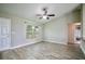 Bright living space with wood-look floors, leading to a glimpse of the en suite bathroom at 30 Olive Cir, Ocala, FL 34472