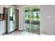 View from inside the home through sliding glass doors to outdoor living space and backyard at 30 Olive Cir, Ocala, FL 34472