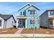 Charming two-story home with light blue siding, a green front door, and a well-manicured front yard at 3034 Voyager Ave, St Cloud, FL 34771
