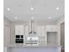 Contemporary kitchen with stainless steel appliances, white cabinets, and bright recessed lighting at 3034 Voyager Ave, St Cloud, FL 34771