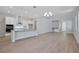 Open-concept living area featuring a modern kitchen and light hardwood flooring, perfect for entertaining at 3034 Voyager Ave, St Cloud, FL 34771