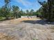View of a home under construction with block walls in a lush, wooded setting at 30551 Saffron Ave, Eustis, FL 32736