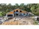 A new home construction featuring modern architectural elements in a wooded homesite at 30551 Saffron Ave, Eustis, FL 32736