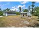 The backyard shows a chicken coop adjacent to the detached garage at 31857 Dahlia Ct, Eustis, FL 32736