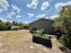 Spacious backyard featuring a utility sink, gardening boxes, and a partially fenced yard at 31857 Dahlia Ct, Eustis, FL 32736