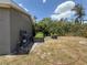 Backyard featuring a utility sink, gardening boxes, and a partially fenced yard at 31857 Dahlia Ct, Eustis, FL 32736