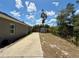 View of the backyard featuring a storage shed, side yard, and new home construction at 31857 Dahlia Ct, Eustis, FL 32736