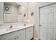 Bright bathroom with double sinks, marble countertops, and large mirror at 31857 Dahlia Ct, Eustis, FL 32736