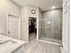 Modern bathroom featuring a glass-enclosed shower, stylish sink, and a spacious walk-in closet at 31857 Dahlia Ct, Eustis, FL 32736