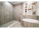 Elegant bathroom featuring a glass-enclosed shower and luxurious soaking tub at 31857 Dahlia Ct, Eustis, FL 32736