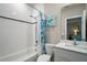 Bright bathroom with white subway tile, a tub, and a modern vanity with a marble countertop at 31857 Dahlia Ct, Eustis, FL 32736