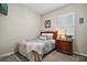 Comfortable bedroom with a bed, a wooden nightstand and a large window at 31857 Dahlia Ct, Eustis, FL 32736