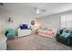 Spacious bedroom with coastal decor, a ceiling fan, and shuttered windows for natural light at 31857 Dahlia Ct, Eustis, FL 32736