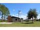 Community center with a brick chimney, a gazebo, a storage shed and a wide open lawn at 31857 Dahlia Ct, Eustis, FL 32736