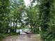 Beautiful lake view of a wooden dock, surrounded by lush trees at 31857 Dahlia Ct, Eustis, FL 32736