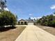 Beautiful home exterior featuring a well-manicured lawn and a spacious driveway at 31857 Dahlia Ct, Eustis, FL 32736