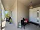 Inviting front porch decorated with a bench, pillows, and a welcoming sign at 31857 Dahlia Ct, Eustis, FL 32736