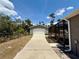 A spacious detached two-car garage with long driveway and screened patio attached to house at 31857 Dahlia Ct, Eustis, FL 32736