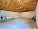 Large, unfinished garage featuring exposed wood beams and concrete floor with a lot of space at 31857 Dahlia Ct, Eustis, FL 32736