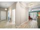 Spacious hallway leading to the main living area featuring tile floors and bright lighting at 31857 Dahlia Ct, Eustis, FL 32736