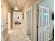Inviting hallway with tiled floor, decorative lighting, and open view to a sitting area at 31857 Dahlia Ct, Eustis, FL 32736
