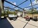 Relaxing outdoor hot tub in screened patio with a view of the lush backyard at 31857 Dahlia Ct, Eustis, FL 32736