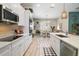 Modern kitchen with white cabinets, stainless steel appliances, island countertop, and tiled flooring at 31857 Dahlia Ct, Eustis, FL 32736