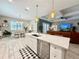 Open-concept kitchen flows into dining and living areas, featuring an island with barstool seating at 31857 Dahlia Ct, Eustis, FL 32736