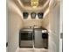 Modern laundry room with front-loading washer and dryer, and organized shelving at 31857 Dahlia Ct, Eustis, FL 32736