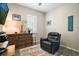 Relaxing living room with a comfortable armchair and a large window at 31857 Dahlia Ct, Eustis, FL 32736