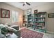 Cozy home office with built-in bookshelves, comfortable seating, and natural light at 31857 Dahlia Ct, Eustis, FL 32736