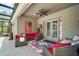 Inviting screened patio with stylish furniture, ceiling fan, and an American flag at 31857 Dahlia Ct, Eustis, FL 32736