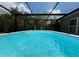 Serene screened-in pool offering relaxation and privacy with lush greenery surrounding at 31857 Dahlia Ct, Eustis, FL 32736