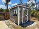 Shed with gray siding, white trim, decorative light, window box, and small window at 31857 Dahlia Ct, Eustis, FL 32736