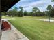 Large outdoor green space featuring a volleyball court, picnic area, and wooden lounge chairs at 31857 Dahlia Ct, Eustis, FL 32736