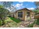 The backyard with a lush lawn, mature trees, a tile roof and an inviting patio at 32543 Hawks Lake Ln, Sorrento, FL 32776
