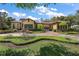 Beautiful front exterior of home with red tile roof, manicured landscaping and brick paved driveway at 32543 Hawks Lake Ln, Sorrento, FL 32776