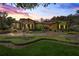 Beautiful front exterior of home with red tile roof, manicured landscaping and brick paved driveway at dusk at 32543 Hawks Lake Ln, Sorrento, FL 32776