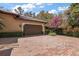 Attached garage and patterned brick driveway lined with manicured hedges and bougainvillea at 32543 Hawks Lake Ln, Sorrento, FL 32776