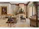 Open living room featuring stone fireplace, travertine floors, coffered ceilings and lots of natural light at 32543 Hawks Lake Ln, Sorrento, FL 32776