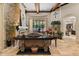 Living room with stone fireplace, coffered ceilings, travertine floors, and lots of natural light at 32543 Hawks Lake Ln, Sorrento, FL 32776