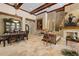 Living room featuring stone fireplace, travertine floors, coffered ceilings, and lots of natural light at 32543 Hawks Lake Ln, Sorrento, FL 32776