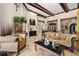 Open living room with travertine floors, stylish furniture, and bar area in the background at 32543 Hawks Lake Ln, Sorrento, FL 32776