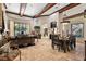 Open concept living room featuring coffered ceilings, tile floors, and large picture window at 32543 Hawks Lake Ln, Sorrento, FL 32776