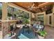 Expansive outdoor living space featuring a stone fireplace, built-in grill, ceiling fan and relaxing seating area at 32543 Hawks Lake Ln, Sorrento, FL 32776