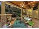Inviting outdoor living space featuring a fireplace, ceiling fan, and wet bar at 32543 Hawks Lake Ln, Sorrento, FL 32776