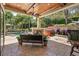 Covered patio with a jacuzzi, outdoor seating area, and lush landscaping, offering a relaxing backyard retreat at 32543 Hawks Lake Ln, Sorrento, FL 32776