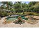Aerial view of a backyard pool and spa surrounded by mature landscaping and comfortable lounging areas at 32543 Hawks Lake Ln, Sorrento, FL 32776